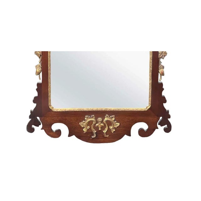 Chippendale George II style carved mahogany mirror depicting a ho-ho bird on top and strawberry stolons . American, 18th...