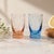 A charming pair of vintage shot glasses featuring a delicate etched starburst pattern, perfect for adding a subtle mid-...