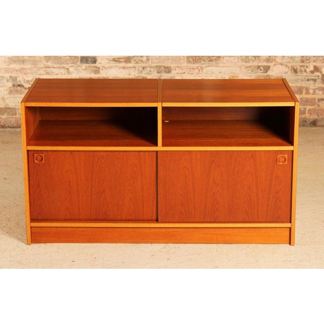 Mid Century Danish media stand / vinyl record player cabinet, circa 1970s. Two sliding doors and a lift up top to...