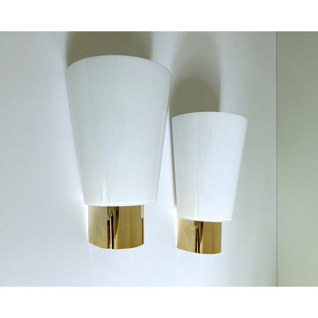 Set of 3 Vintage Limburg sconces, featuring a gilded brass base, conical shaped glass shades. Very good condition...