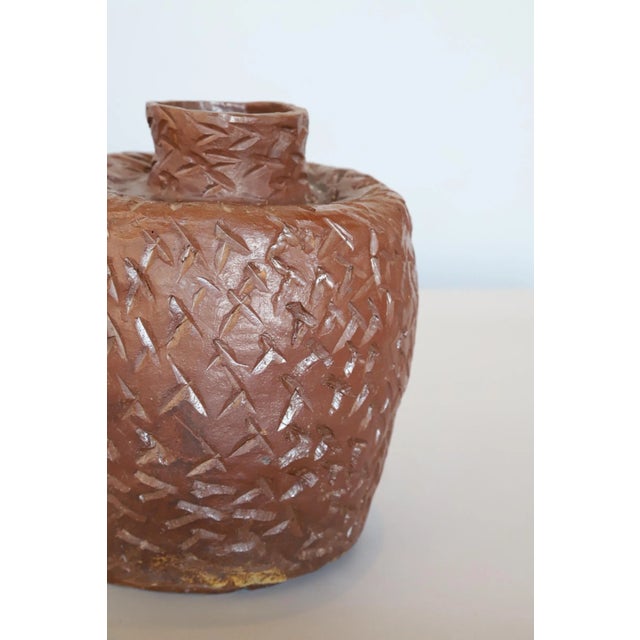 Elegance in imperfection. Fun handmade textured ceramic pot. Photographed with Charles Pollock Knoll chair and Woodard...