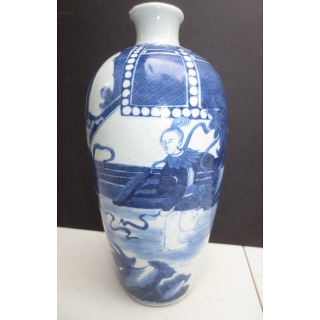 Chinese blue and white vase with musicians and dancing girls. Plum-shaped vase with a soft denim blue glaze and with reign...
