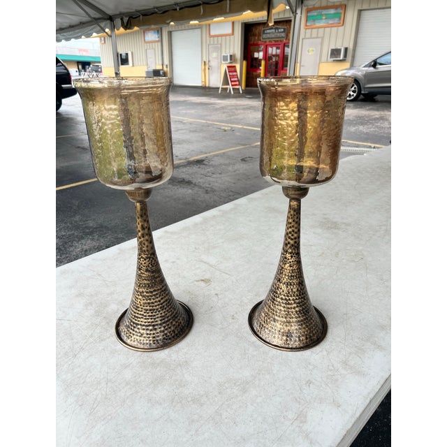 Add striking vertical dimension and warm illumination to your space with this stunning set of two tall pillar candle...