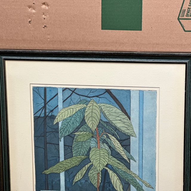 Vintage signed lithograph depicting several potted houseplants in a window. Pencil signed and numbered rom an edition of...