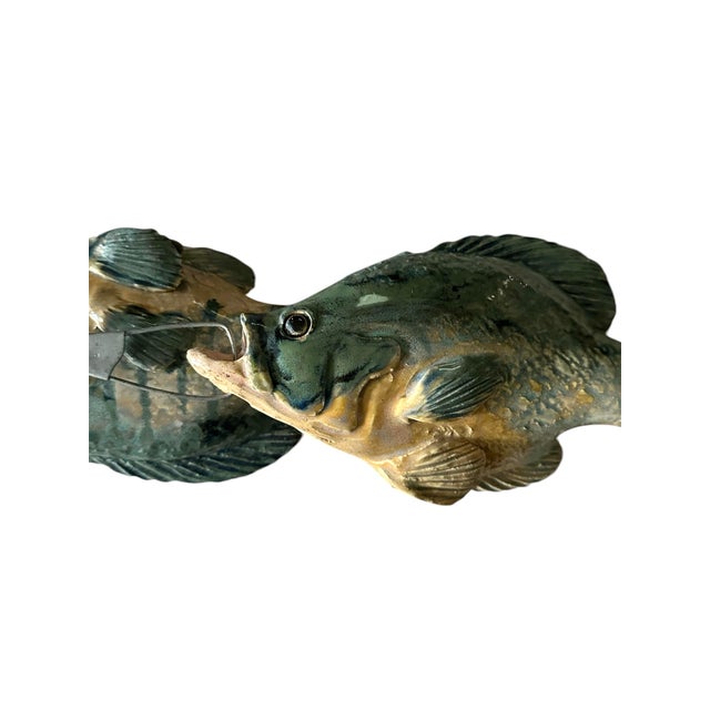 A vintage, handmade ceramic fish sculpture. Features a trio of hand molded fish glazed in a deep blue-green shade, linked...