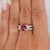 GIA-certified 2.00 carat natural ruby of Burma origin is set in PT900 platinum with a rounded oval profile and flanked by...