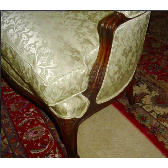 This is superb small love seat in Louis XV style circa 1890s. The frame is walnut in original finish, carved with floral...