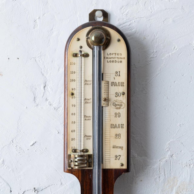 A late 19th century rosewood stick barometer by Loftus of London. 3 ¼ inches wide by 36 inches tall; 3 inches deep