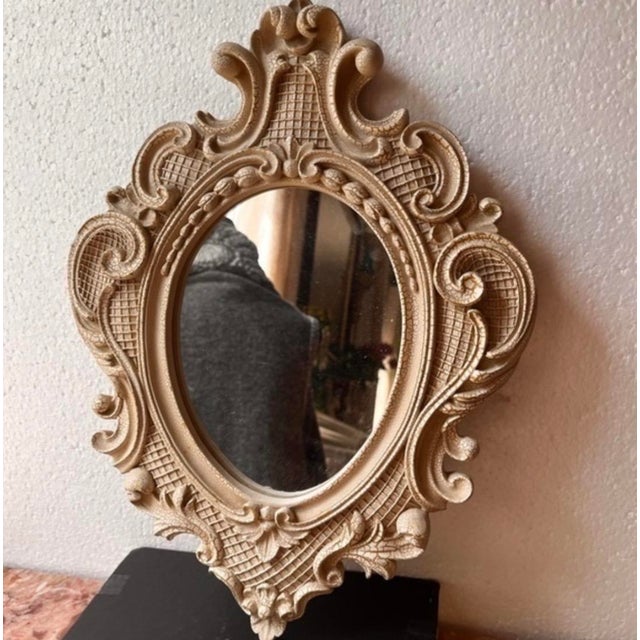 Vintage ornate mirror. Ivory color with crackle effect. Size 14”x11”. Wall accent mirror.