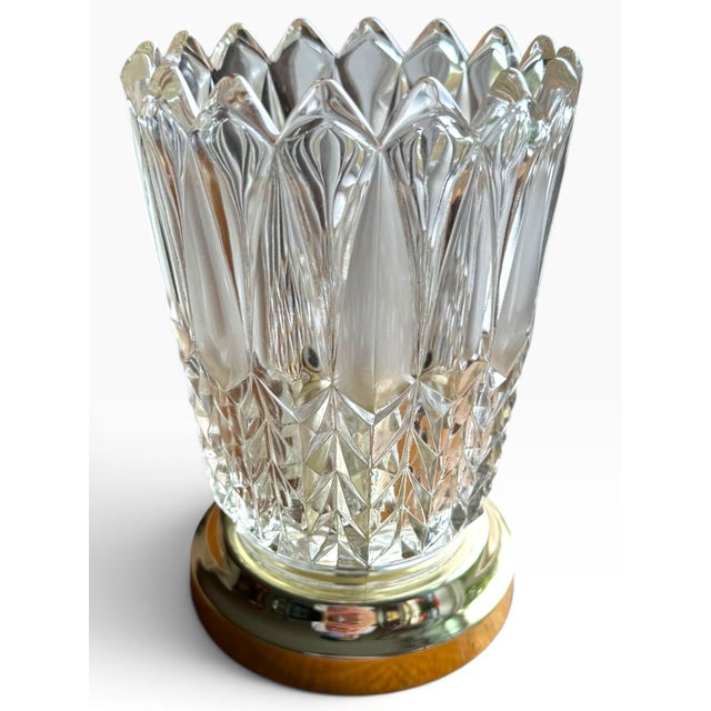 Striking vintage cut-glass table lamp featuring an intricate geometric pattern of faceted diamonds, elongated panels, and...