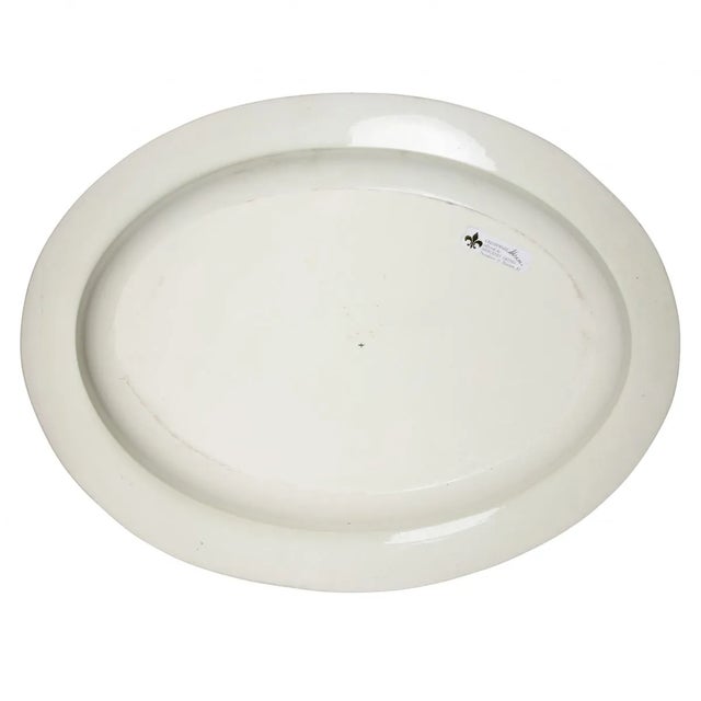 Oval with decorated border and armorial crest. Marked Wedgwood. In excellent condition. A few small chips. With Moulton...