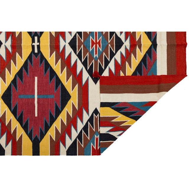 Elevate your space with this striking Southwestern flat-weave wool rug, featuring a bold, vibrant Eye Dazzler dynamic...