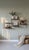 Wall shelf comprising four gold-plated twisted steel uprights and six black lacquered metal shelves. Upright height: 58 cm...
