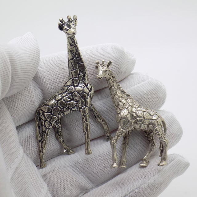 A delightful and characterful duo, this vintage Italian miniature set features two finely crafted giraffes, captured with...