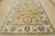 This modern traditional Oushak rug is hand-knotted with an all-wool pile on a cotton foundation. This rug is new and in...