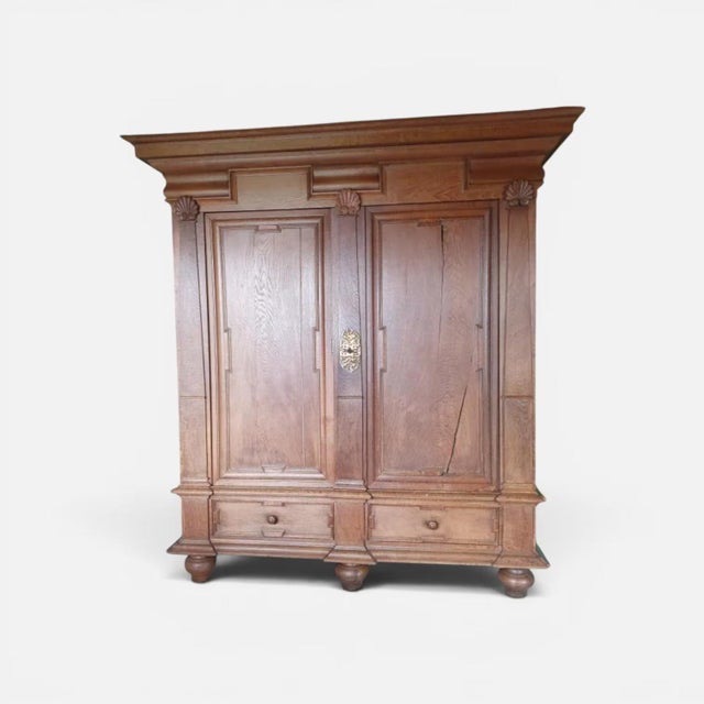 - Baroque wardrobe (Schrank), likely northern Germany, 18th century - Solid oak throughout - Two tall panelled doors over...