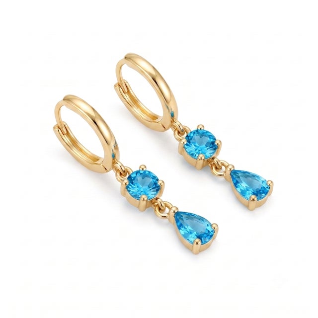 Add a vibrant pop of ocean-blue brilliant shimmer to your jewelry collection. These stunning dangle earrings feature...