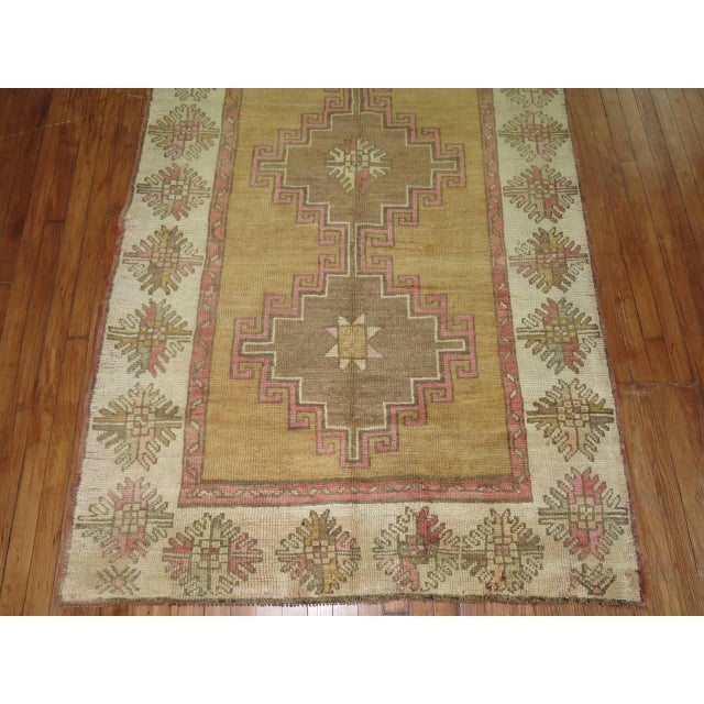 One of a kind Turkish Gallery size runner with a camel field, ivory border, brown medallions with pink accents on field...