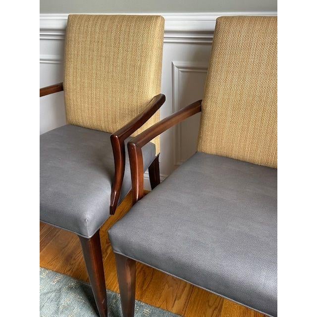 Family Friendly Baker dining chairs with a refined, transitional silhouette. Upholstered backs in a warm neutral woven...