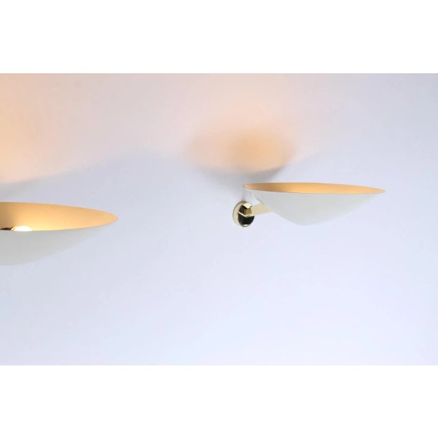 Impressive set of two large metal uplights / wall sconces designed by Giuseppe Ostuni for Oluce in 1951. Model called...