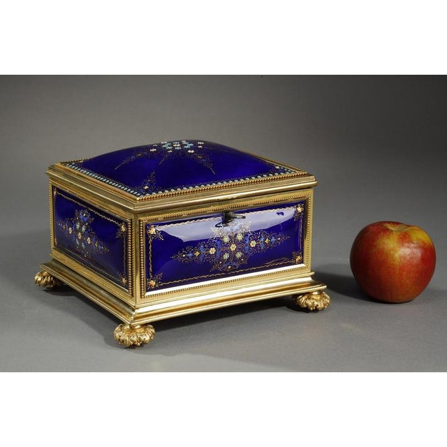 Square box of Bresse-blue enamel with gilt bronze mounts. The five sides are composed of convex plates that are decorated...