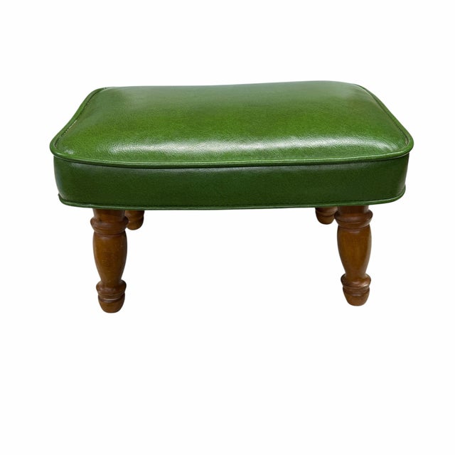Vintage mid century green vinyl / faux leather footstool. Measures 16.5” w x 10.5” d x 10” h. Two tiny slits on one side....