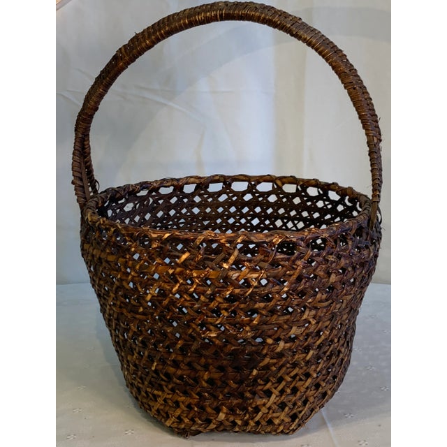 Both decorative and functional, this hand caned Americana-style basket dates to the late 1800s or early 1900s. Well made...