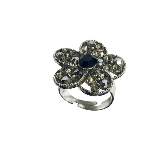Beautifully crafted vintage ring, with a unique flower shape and faux diamond accents. The ring features a black centered...