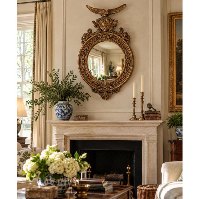 A beautiful large Federal-style convex mirror, crowned by a finely modeled spread-wing eagle above an elaborate...