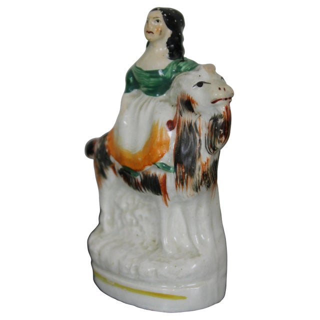Antique Staffordshire porcelain figurine of a girl riding a goat.