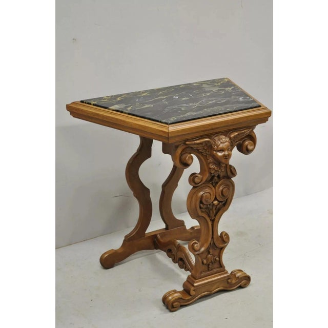 Italian Renaissance Figural Carved Marble Top Side Table with Winged Cherub Head. Item features has an inset marble top,...