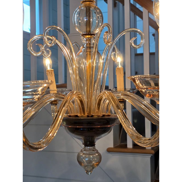 Elegant eight light Murano chandelier in light amber color works in myriad decorative styles