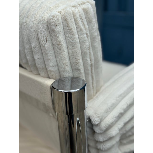 A bold little throne with a soft voice. This postmodern lounge chair pairs a sleek chrome frame with plush, channel-tufted...