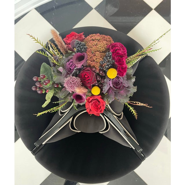 A petite circular chaise with sweeping curved backs featuring oval detailing. An outstanding statement piece for a foyer,...