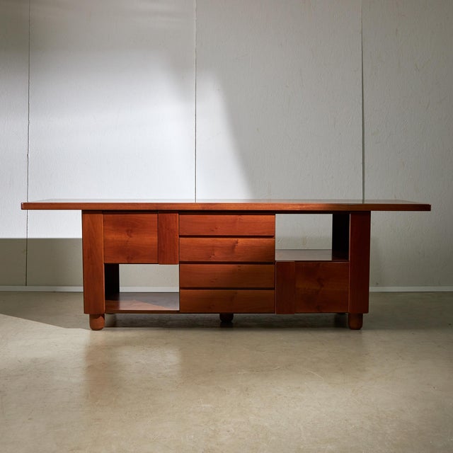 Introducing a piece of vintage elegance: this Italian walnut sideboard from the 1970s, designed for Mobil Girgi. It...