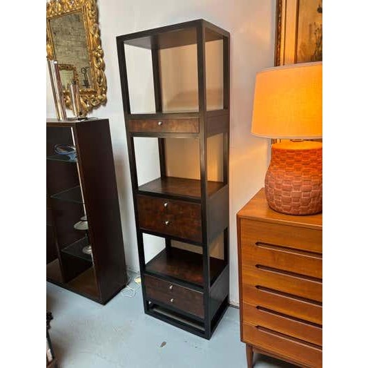 Tall Cabinet perfect to use for storage and display! Drawer fronts and surfaces have a faux finish. Outer construction is...