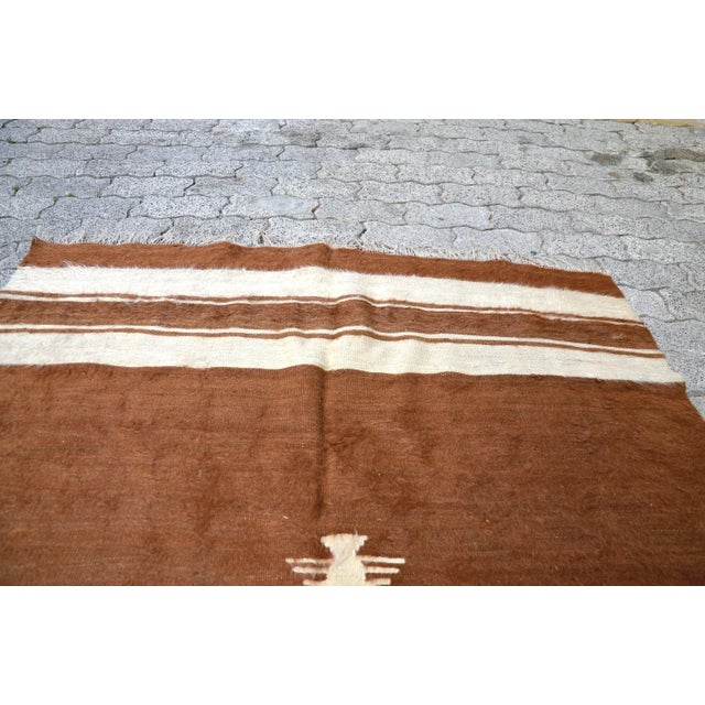 This is a vintage Turkish Anatolian kilim rug from the 1960s. The piece was hand-woven.