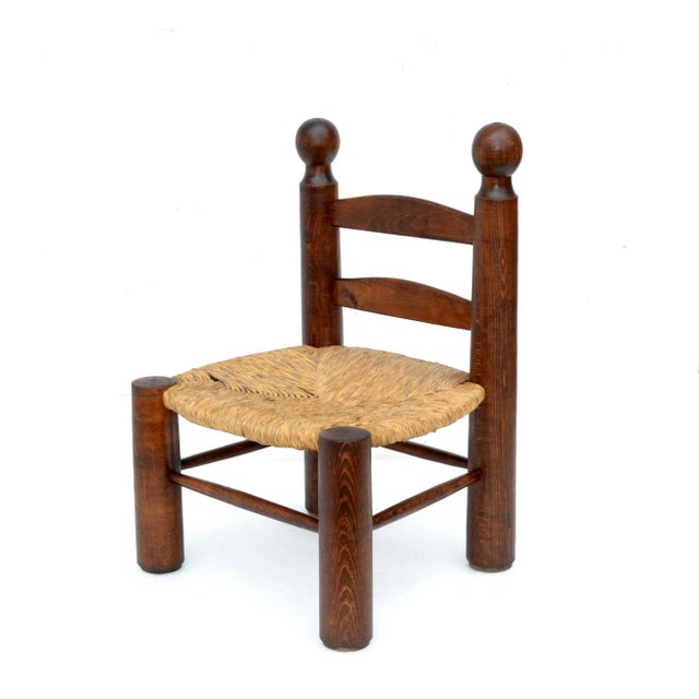 Very rare Kid's Chair in the manner of Charlotte Perriand. Turned oak wood core with handwoven rush seat which is in...
