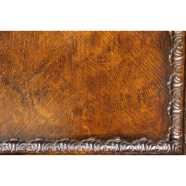 This antique oak sideboard, crafted in the late 19th and early 20th centuries, in a neo-Renaissance style and finely...