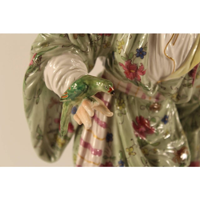 Woman with a parrot, KPM Berlin, 19th century.. Beautiful figurine of a standing woman in oriental dress holding a parrot...