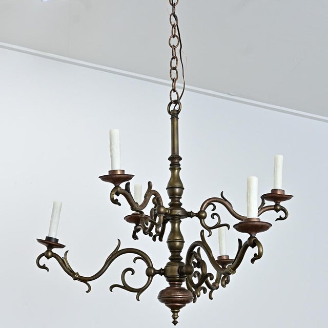 A six-light brass chandelier from 19th century Portugal, modeled after the Dutch style with a central column from which...
