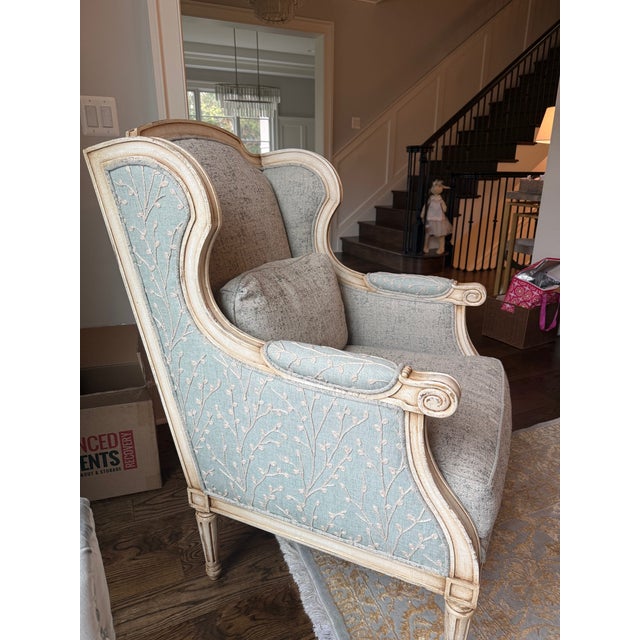 An elegant wingback chair from the John Richard Collection, showcasing refined French-inspired craftsmanship and timeless...