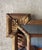 An elegant vintage Hollywood Regency wall mirror featuring a richly gilt frame with crisp geometric detailing and...