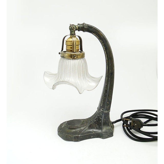 The bedside lamp comes from Austria-Hungary in 1900-1910. It was made in the Art Nouveau style. The lampshade is made of...