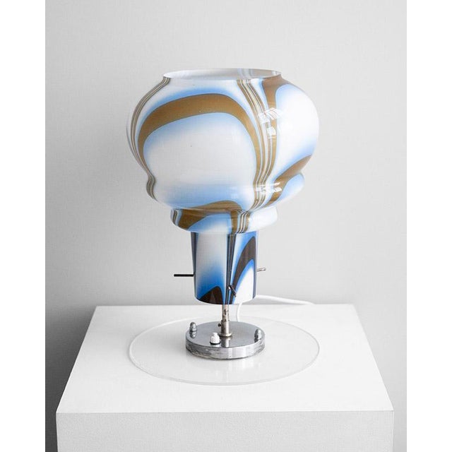 The 1970s table lamp was made by the Italian glass workshop AV Mazzega on the island of Murano, Italy. Mazzega was founded...