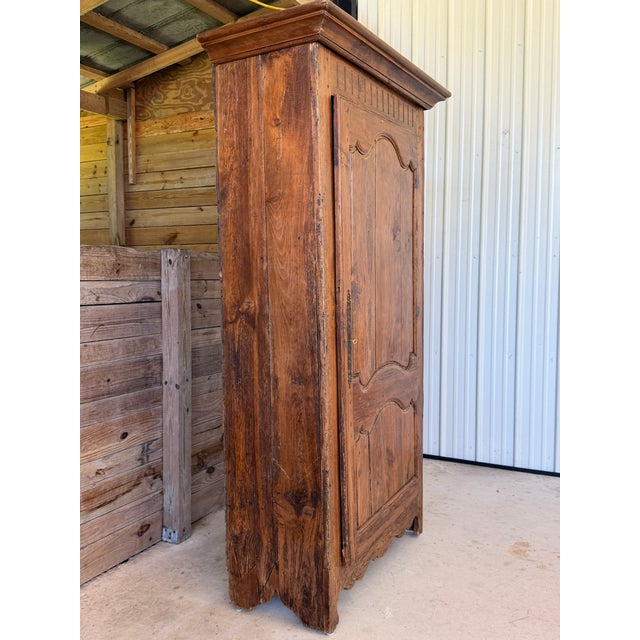 A wonderfully timeworn 18th-century French Provincial bonnetière or single-door armoire, dating to approximately the late...