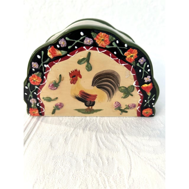 Charming hand-painted ceramic napkin holder in a French Country rooster and floral motif.