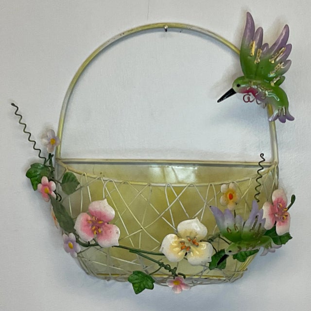 This is so pretty. We have here a hand painted tole wall pocket-basket. It features two colorful hummingbirds in green and...