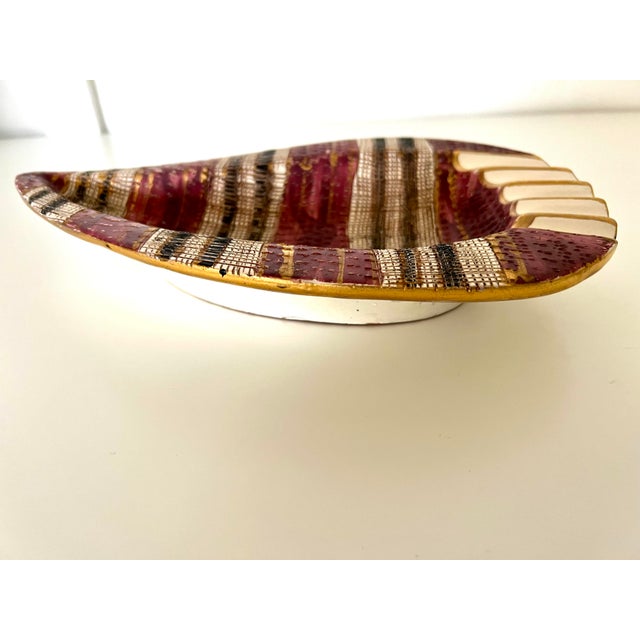 Beautiful and rare Bitossi ashtray/dish. Scratch texture surface with 24 k gold highlights around the reds and pinks....