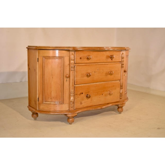 19th century English pine dresser base with bowed front. This piece has a lovely two board top and a scalloped and beveled...